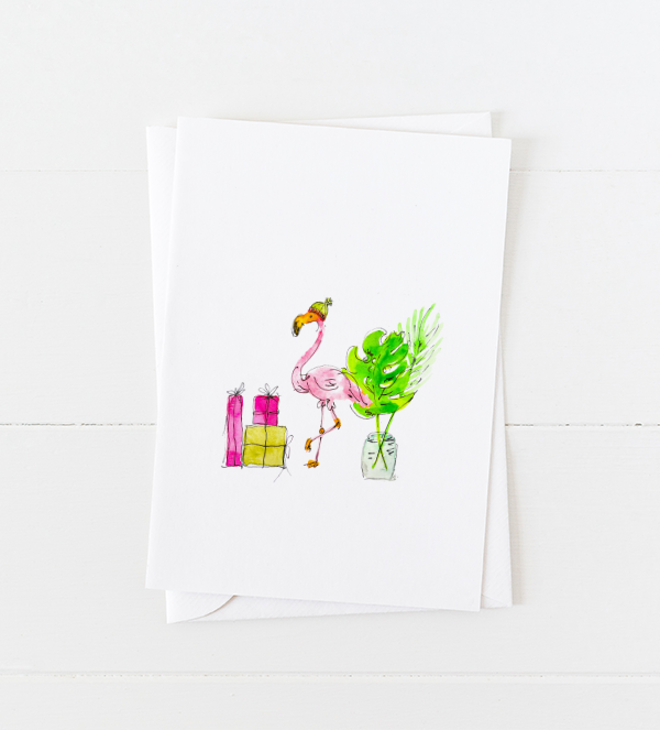 Cute pink flamingo doodle wearing a knit cap next to holiday gifts, pointed flap envelope